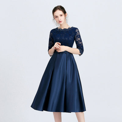 Navy blue dress with lace sleeves on a light gray background